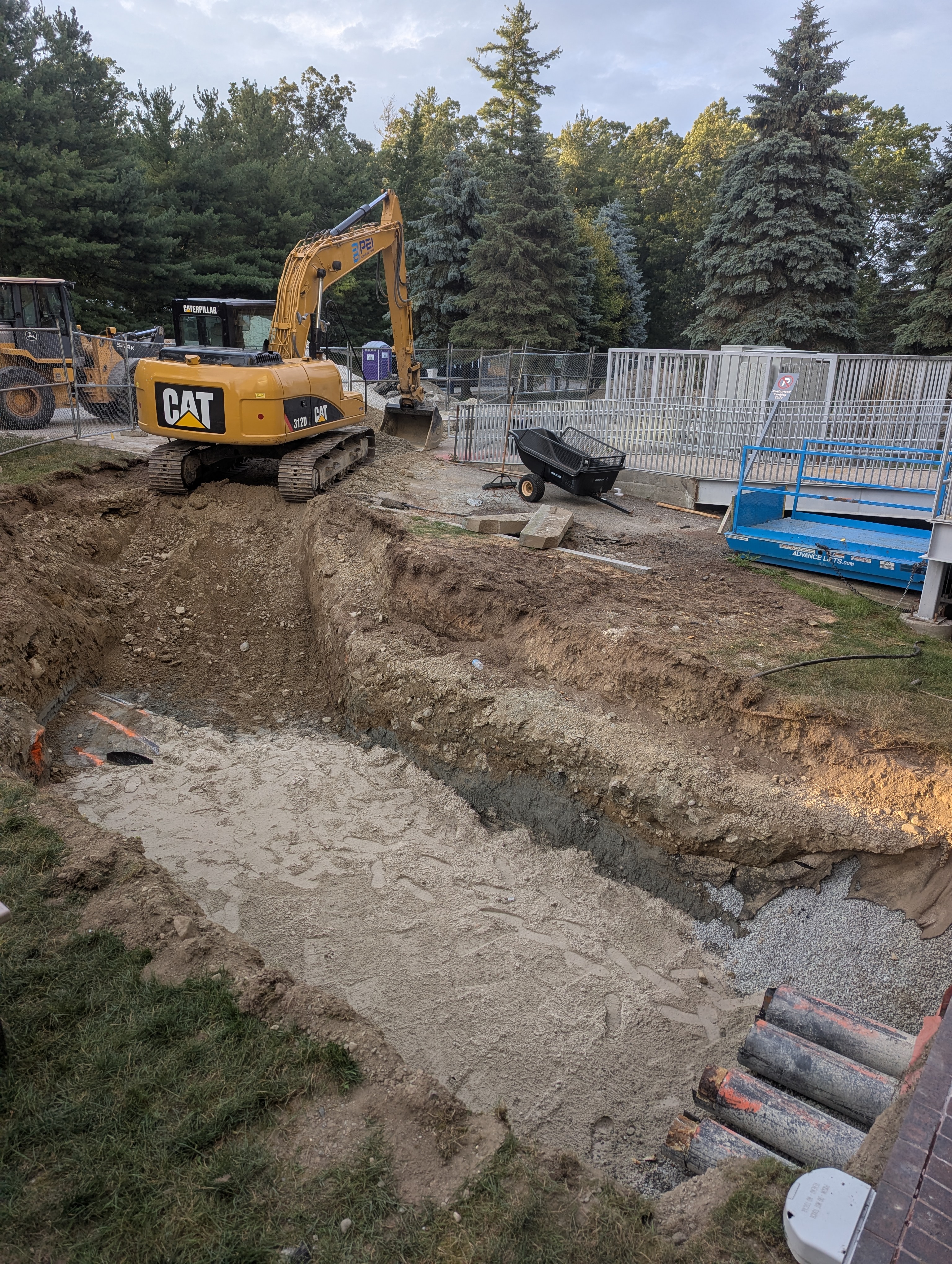 Excavation on back side of MAC at building pipe entry.