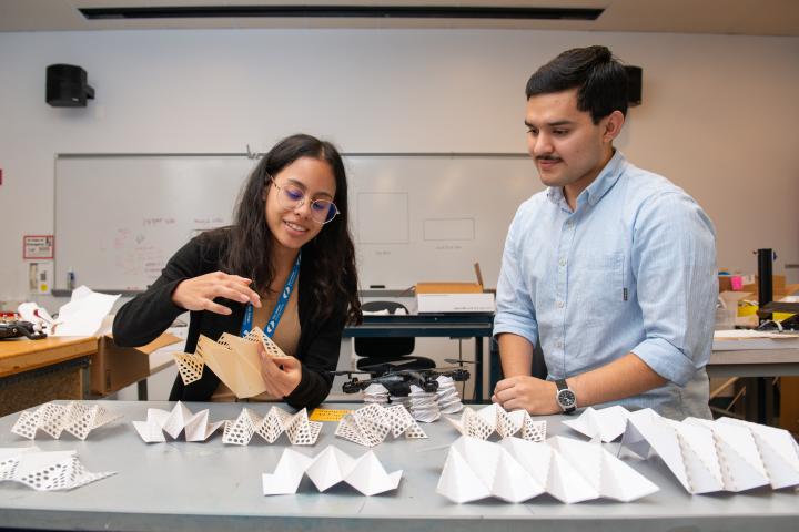 Two Olin students work in a lab on a research project