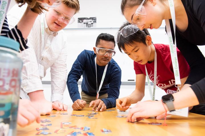 Olin College of Engineering students work together on a puzzle project