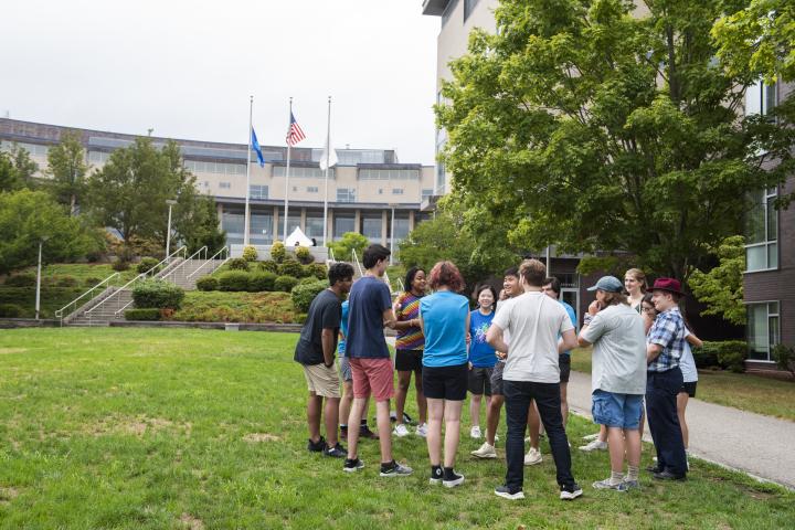 team of orientation students gathered on the great lawn