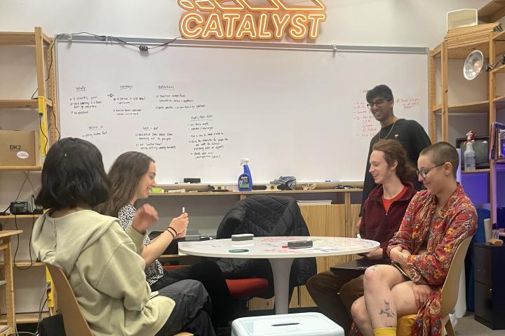 Members of Olin Catalyst - the student-run hub for entrepreneurship, talk in an classroom on campus.