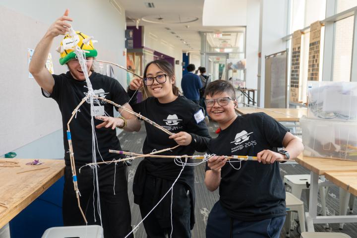 Three Olin Candidates posing together with an engineering project