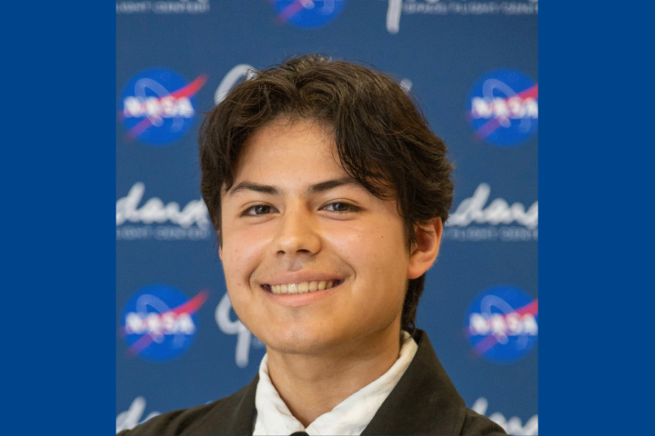 Mateo Otero-Diaz ’28 stands in front of a NASA background.