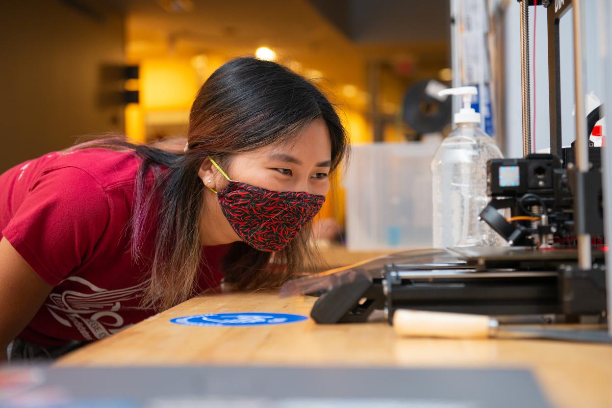 A student at Olin College operating a 3D Printer