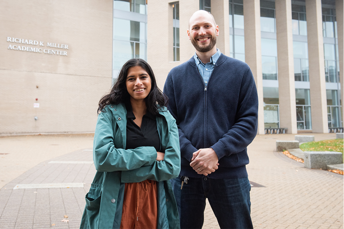 Erhardt Graeff, assistant professor of social and computer science and Shreya Chowdhary ’22." Two people - a student and a professor - stand outside on campus facing the camera head-on