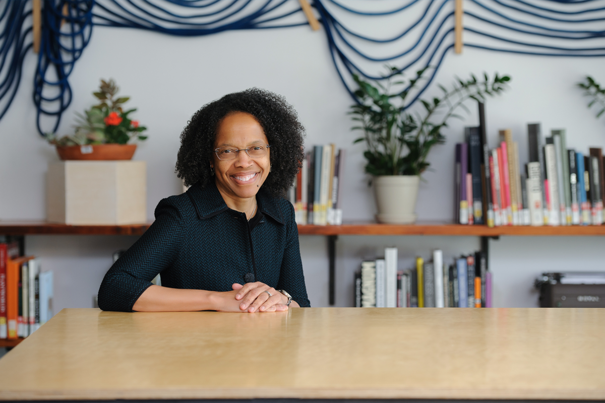 A photo of a woman sitting behind a table