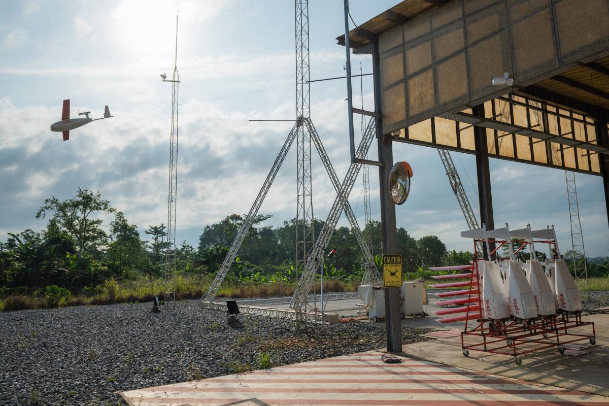 The Zipline auto-delivery system (a small white aircraft) takes off into the skies of Ghana. The Zipline auto-delivery system (a small white aircraft) takes off into the skies of Ghana.