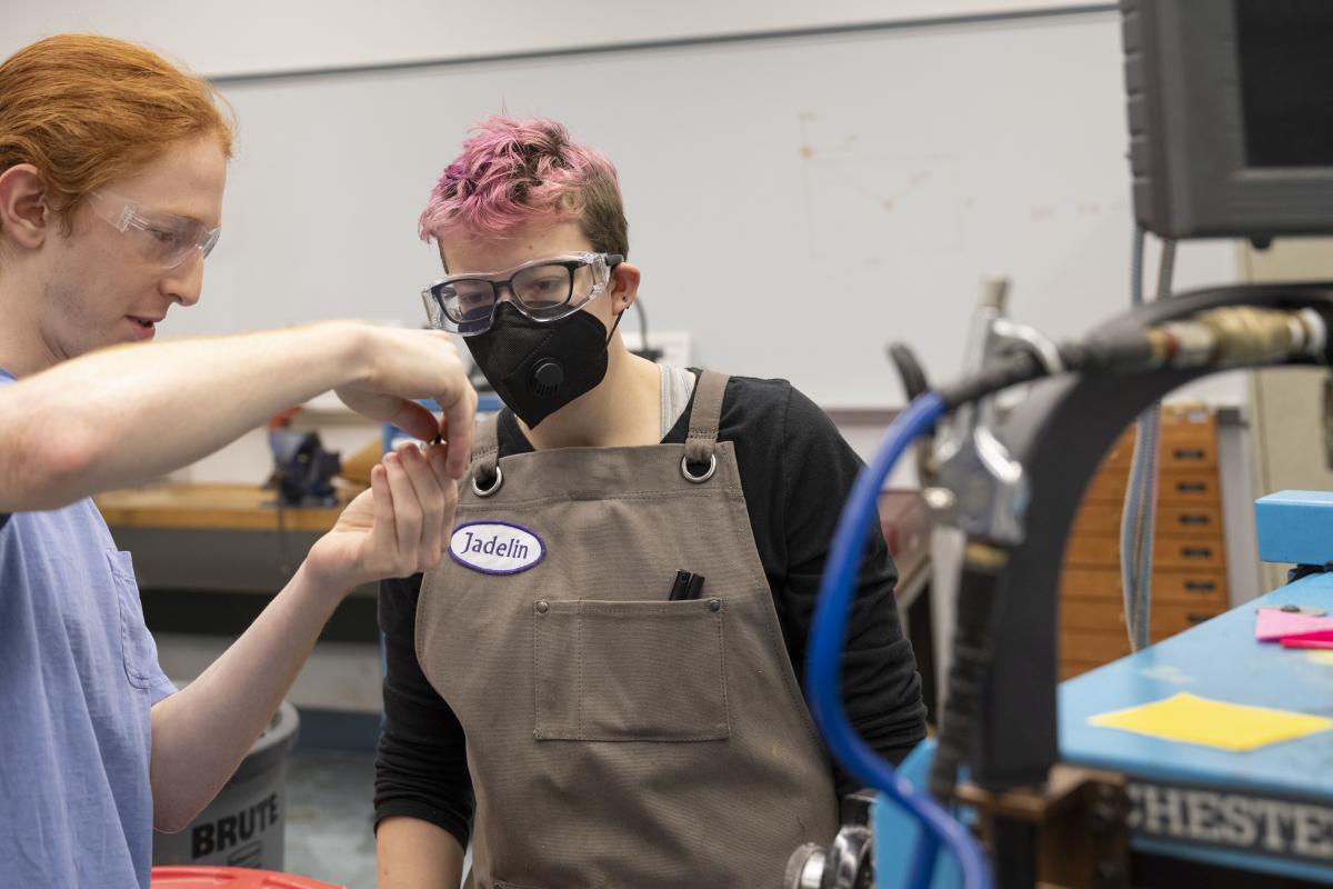 Student Shop Assistant helping fellow peer Student Shop Assistant helping fellow peer