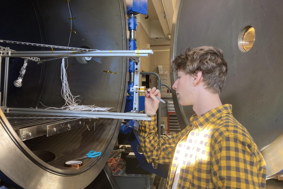 James Jagielski '25 is pictured marking a ceramic terminal block, a component that allows electrical connections to be made to a thruster. A student is pictured marking a ceramic terminal block, a component that allows electrical connections to be made to a thruster.