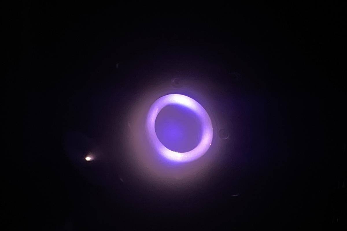 The glowing substance is a plasma ejected from the thruster. The glowing substance is a plasma ejected from the thruster.