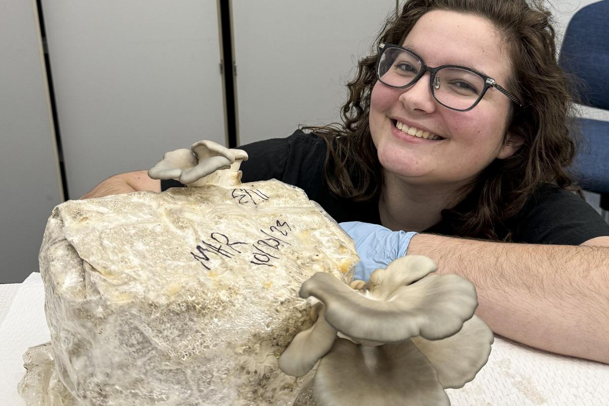 Student Maddy Robertson with class grown mushrooms. Student Maddy Robertson with class grown mushrooms.