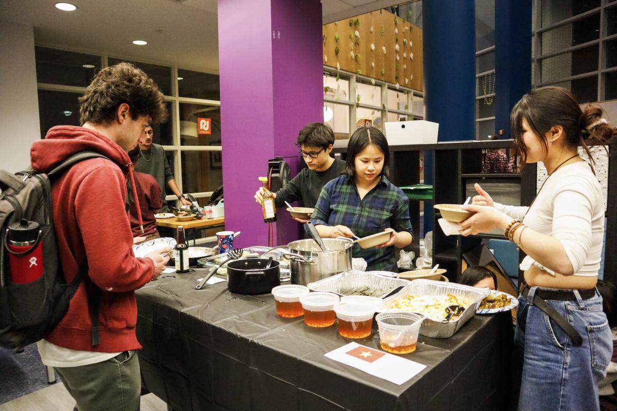 Students serve their dishes at the Olin Multicultural Fair. Students serve their dishes at the Olin Multicultural Fair.
