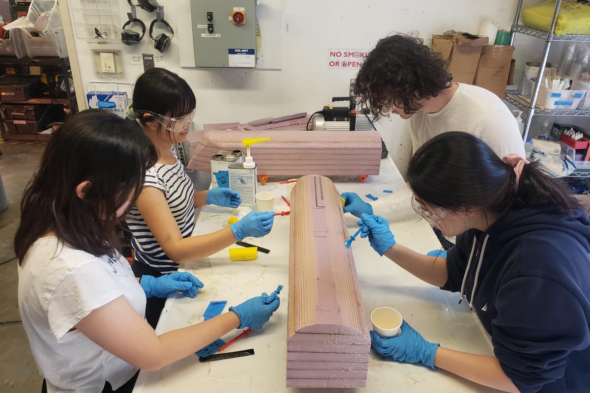 Four of the Olin CREST Lab students work during the early stages of preparing the vessel.