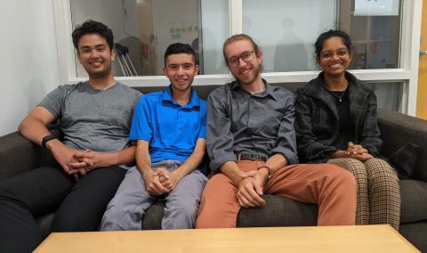 4 person student team seated on couch