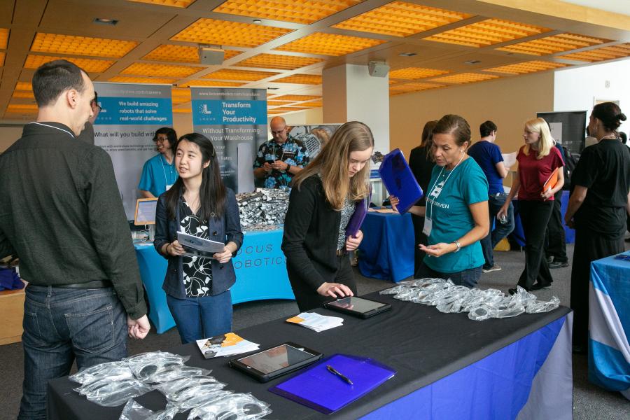 A scene from an Olin College career fair A photo of a group of students and employers mingling at a Career Fair
