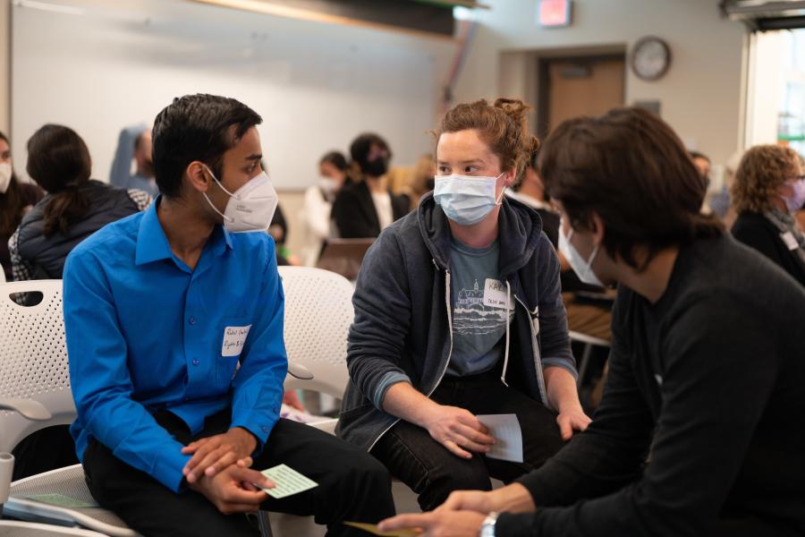 Three students confer during the ADE Showcase in 2021.