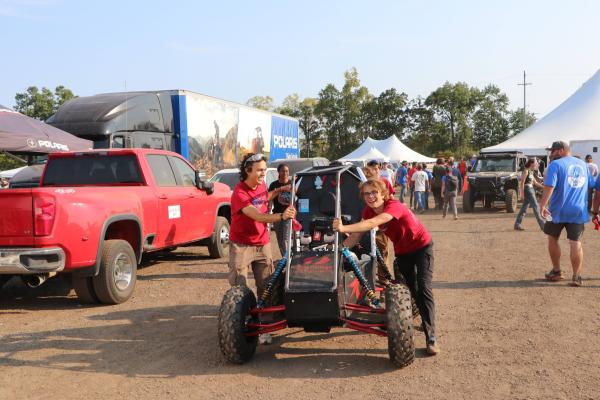 Olin Baja SP 25 - Students pushing car at SEA competition