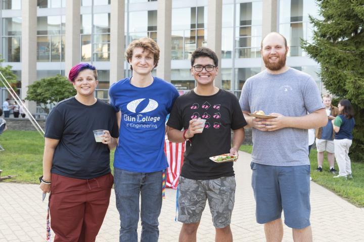 Four people standing outside