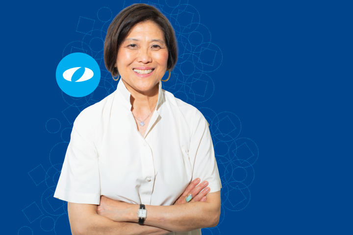 Olin College of Engineering President R. May Lee, visionary entrepreneur and education leader, stands with her hands folded.