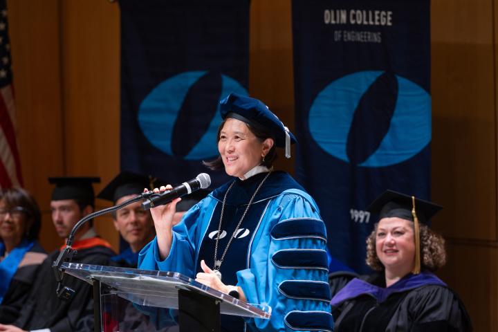 President Lee speaks from the podium on stage in the Norden Auditorium during her inauguration as President of Olin College of Engineering