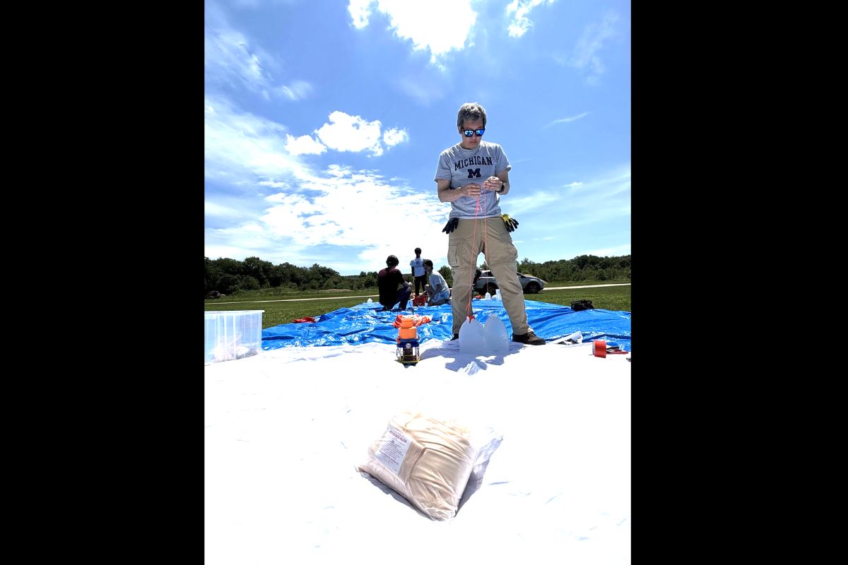 Olin Professor Christopher Lee is pictured tying weighted jugs together, which will serve as part of a payload attached to a high-altitude balloon. Olin Professor Christopher Lee is pictured tying weighted jugs together, which will serve as part of a payload attached to a high-altitude balloon.