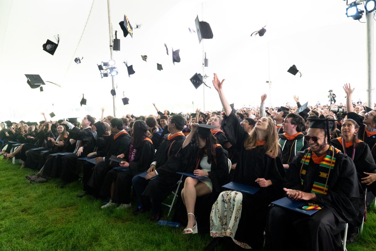 Olin College Class of 2025 graduates throw their caps into the air during Commencement exercises in May 2025.