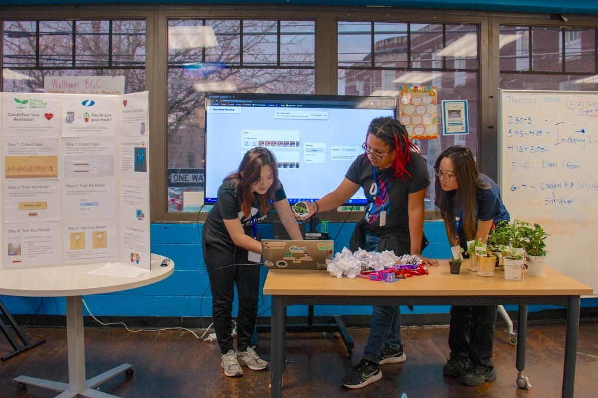 Ideas Become Impact founders work together at one of their events. 