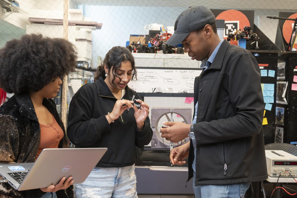 Olin students are seen working with Professor Kenechukwu Mbanisi on a robotics and software project for Hummingbird Systems, LLC.