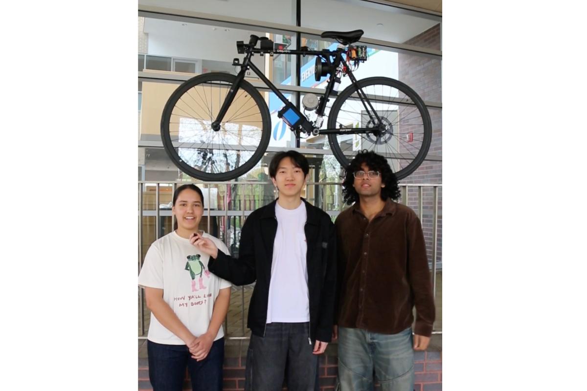 Olin College of Engineering first-year students pose with their autonomous self-balancing bike.