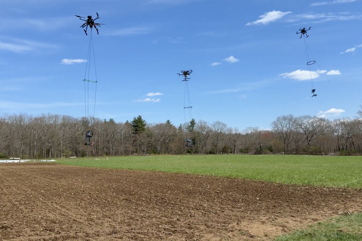 Olin Robotics Lab's Hydrofleet drones carrying sampling payload over a field