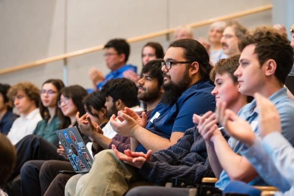 students clapping in stadium seating in auditorium for SCOPE Summit
