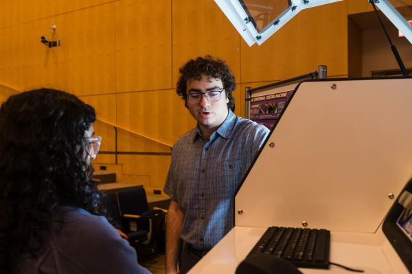 Students demonstrating their project to a SCOPE Summit visitor.