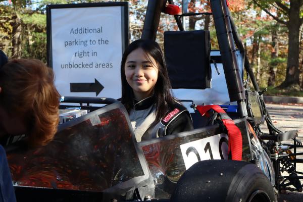 An Olin OEM member sits in their car. 