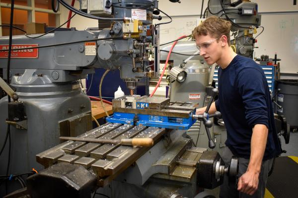 An Olin OCTAL project team member works in the machine shop.