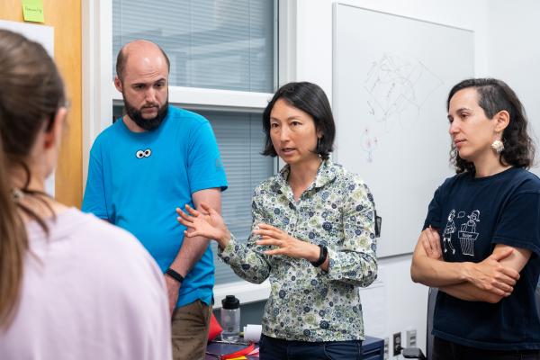 An Olin faculty member speaks with Summer Studio participants.