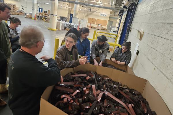 Students stand in front of a box with old film. 