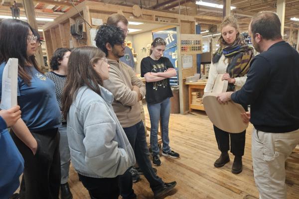 Staff at O&G Studio speaking with students. 