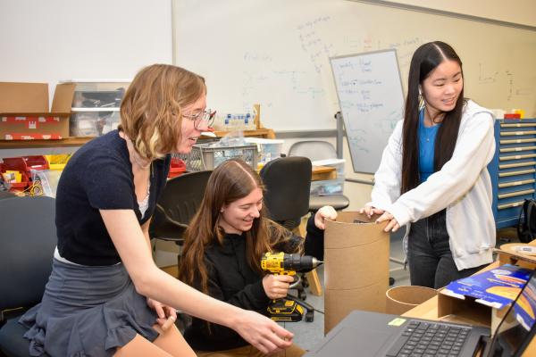 Three students work on their MechProto Build Challenge project. 