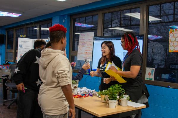 A photo of IBI members handing out snacks to Workshop participants.