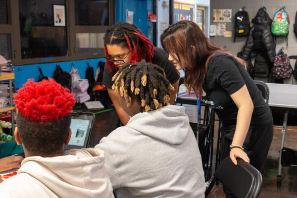 IBI members are pictured instructing two workshop participants.