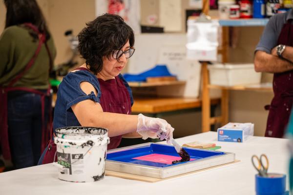 A Makerspace Institute participant screen printing. 